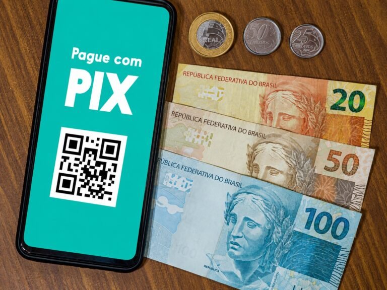 Pagamento via Pix ao lado de dinheiro em espécie em reais